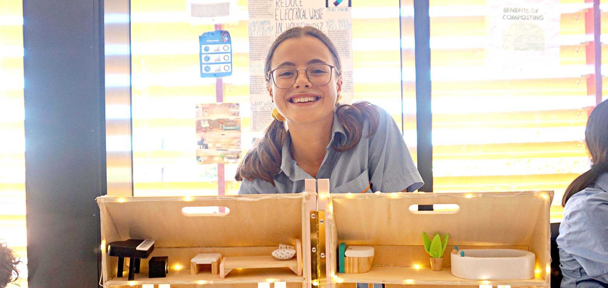 Amelia Mitchell from St Mary’s College with her team’s model app-controlled smart home, designed to reduce residential electrical energy waste.