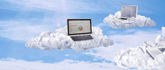 Three laptops sitting on piece of crumpled paper